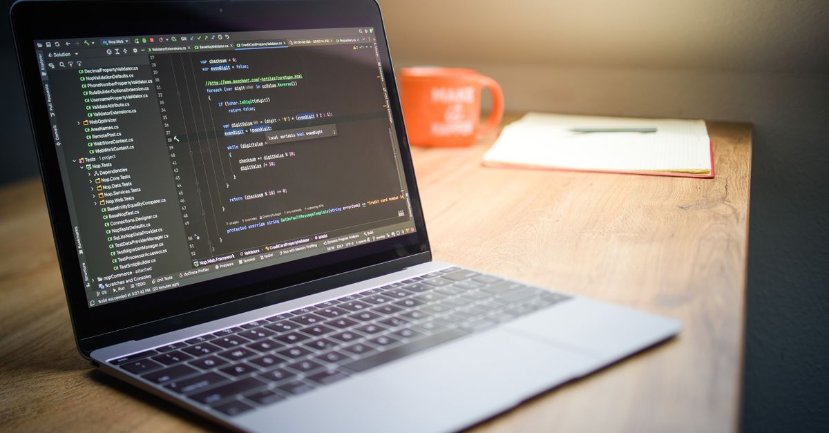 Developer workspace with code on screen and coffee, representing the discovery phase